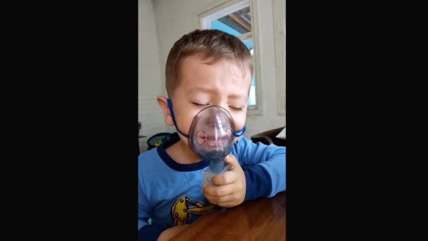 Un niño de 3 años es tratado con un nebulizador. — Vídeos de Stock