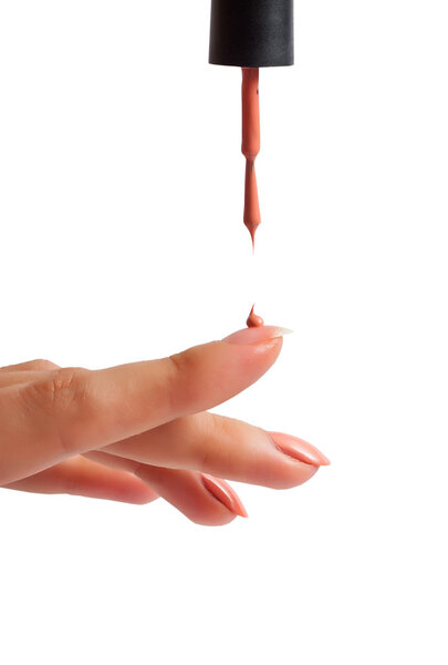 A drop of polish on the nail. Isolated on white background.