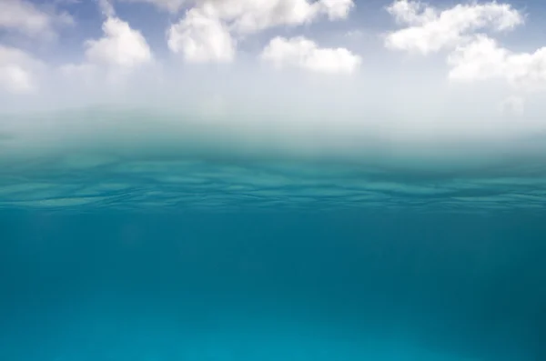 Underwater scene in the bottom and sky with clouds on the top — Stock Photo, Image