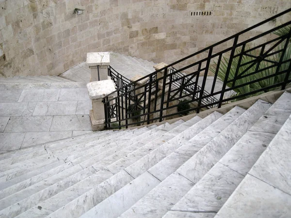 Long staircase descent in gray marble with black iron railing — Stock Photo, Image