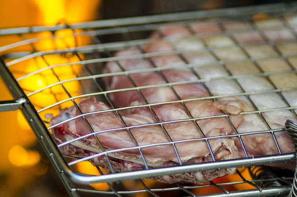 Grill with meat for barbecue fire in background — Stock Photo, Image