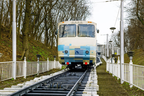 Kiev, Ukraine - March 8, 2016: White funicular train coming down with passengers