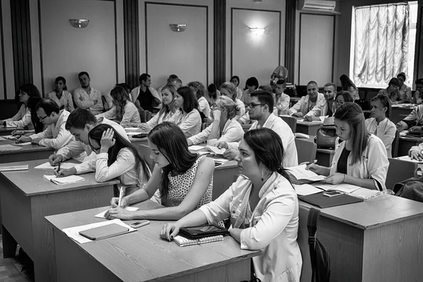 Kiev, Ukraine - July 6, 2015: dentists, doctors, students at lecture black and white HDR effect