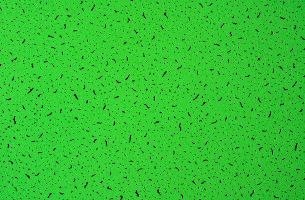 Green abstract grunge paper macro texture with black spots — Stock Photo, Image
