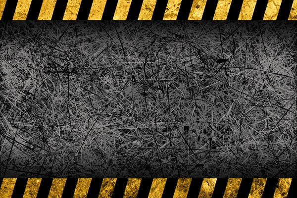 Grunge fond gris foncé avec rayures d'avertissement noires et jaunes — Photo