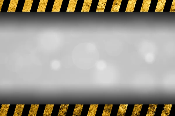 Abstrakter grauer Hintergrund mit schwarzen und gelben Warnstreifen — Stockfoto