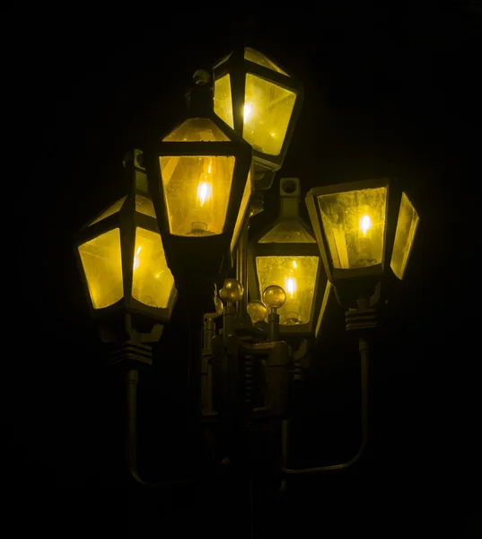 Pole with night lights isolated on black background — Stock Photo, Image