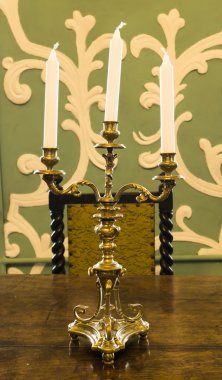 Gold candlestick with candles on the table