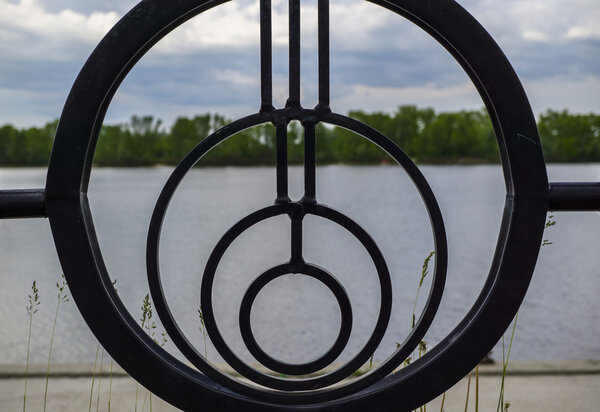 Round fence, river and sky