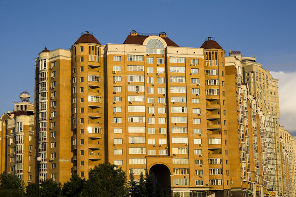 Kiev, Ukraine - July 15, 2015: Modern multi-storey orange big house on background of blue sky