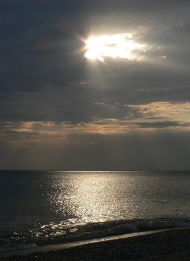 Sunset Bulvarında gri bulutlu gökyüzü, ışınları ışık ve Plajı ile deniz