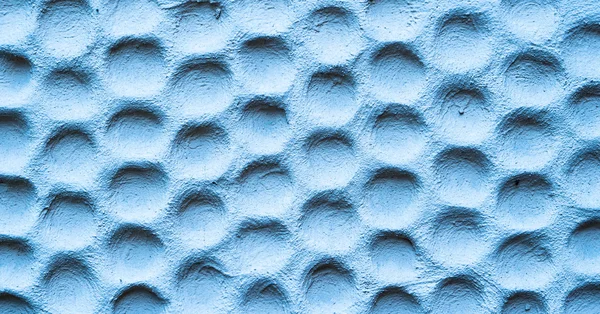 Textura de parede azul rebocada em forma de favos de mel — Fotografia de Stock