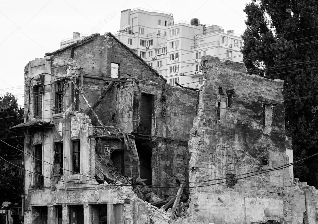 Old ruined house in city after bombing black and white