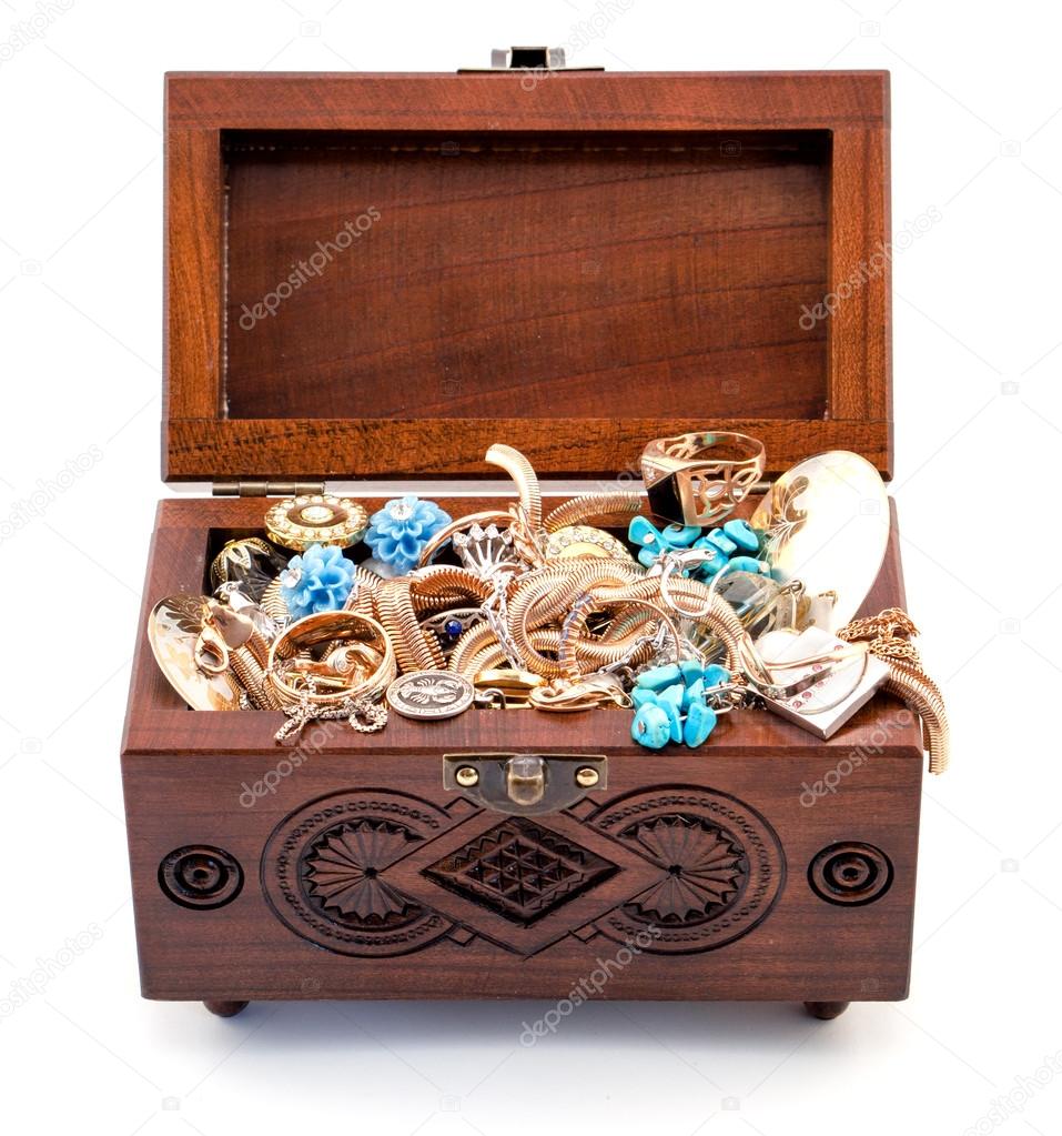 Opened oak wood carved casket handmade with jewelry isolated on white