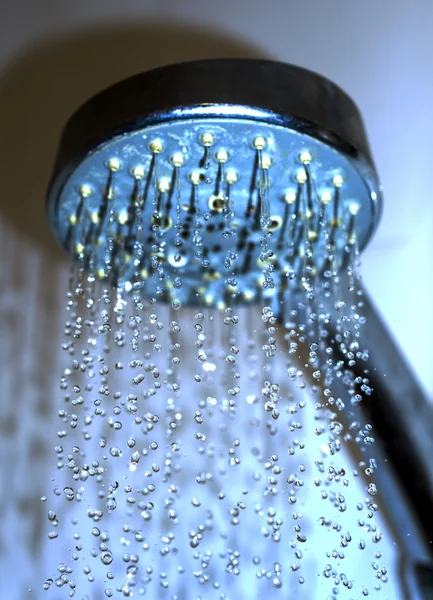 Water drops close-up dripping from the shower blue filtered — Stock Photo, Image