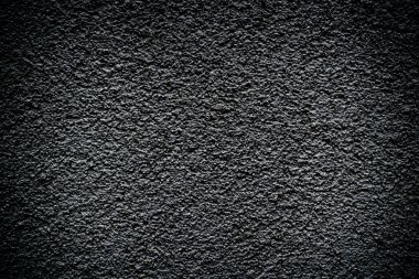Black revetment wall putty high contrasted with vignetting effect macro texture background