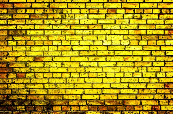 Texture of golden brick wall high contrasted with vignetting effect — 图库照片