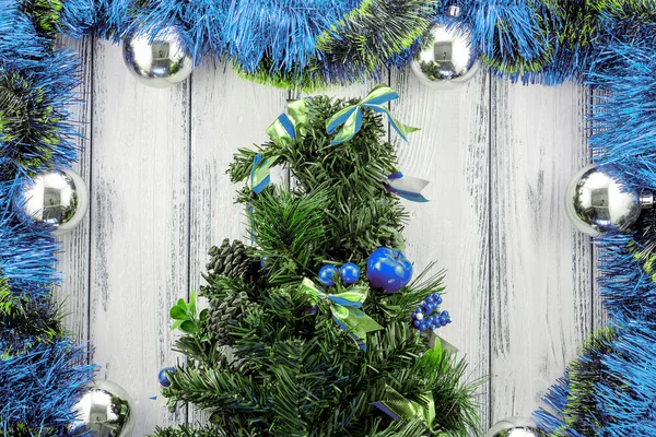 New year theme christmas tree with blue and green decoration and silver balls on white retro stylized wood background — Φωτογραφία Αρχείου