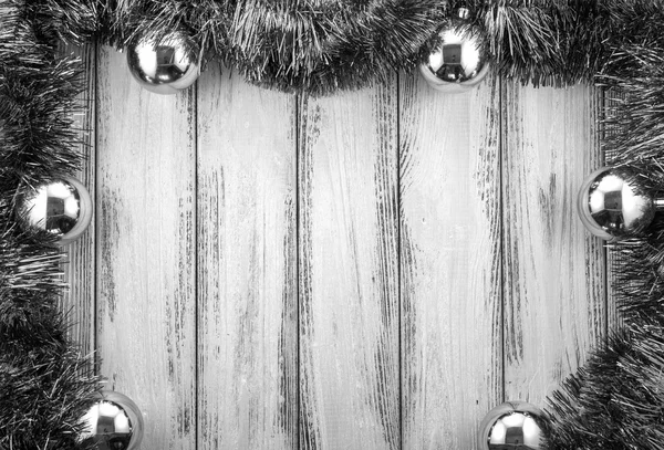 New year theme christmas tree decoration and balls on retro stylized wood background black and white — Stockfoto