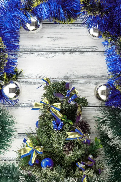 New year theme: christmas tree with blue and green decoration and silver balls on white retro stylized wood background — Stock Photo, Image