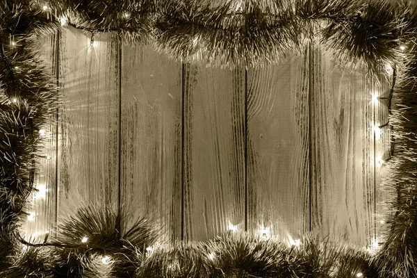 Tema nuovo anno: albero di Natale decorazione e ghirlanda con luci su sfondo in legno retrò stilizzato marrone filtrato — Foto Stock
