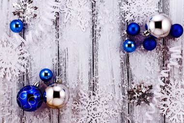 Yeni yıl tema: Noel ağacı beyaz ve gümüş süslemeleri, mavi topları, kar, kar taneleri, serpantin beyaz retro stilize ahşap arka plan üzerinde pembe aydınlatmalı