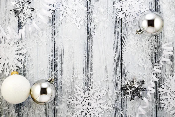 New year theme: Christmas tree white and silver decorations, balls, snow, snowflakes, serpentine on white retro stylized wood background — Stock Photo, Image