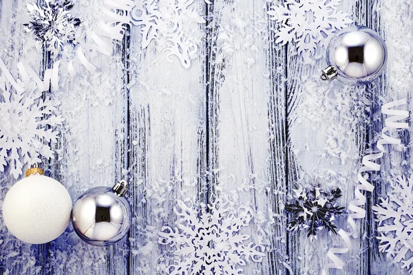 New year theme: Christmas tree white and silver decorations, balls, snow, snowflakes, serpentine on white retro stylized wood background with violet backlight — Stock Photo, Image