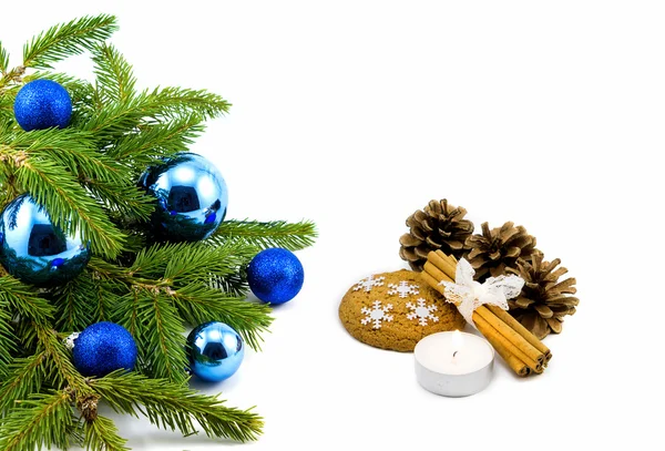 New year theme: Christmas tree, blue balls, decorations, candle, snowflakes, cookies, cones, cinnamon isolated on white — Stock Photo, Image