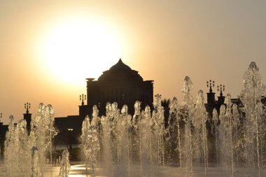 Kum dolu gökyüzü Abu Dabi 'de gerçek üstü altın bir gün batımı yaratıyor..
