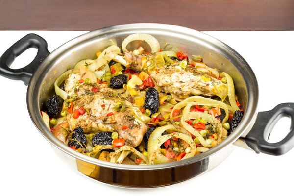 Healthy food, stewed dietary rabbit meat with various vegetables in pan, close-up, top view