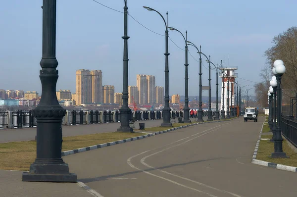 A row of lamps on the embankment of the Amur River. View of China from Russia in the morning.