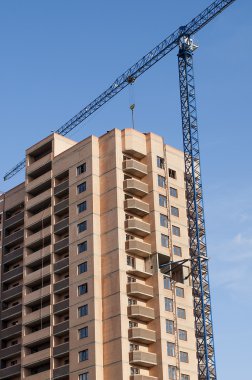 Side view of the new buildings and high-rise crane