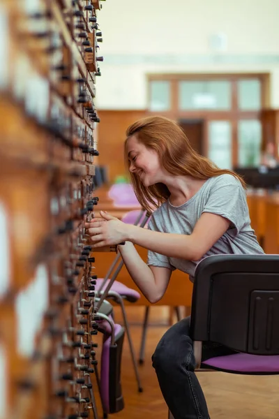 Joyful Redhead Girl Looking Cabinets Drawers Public Library — Stock Photo, Image