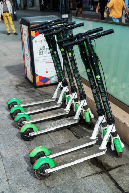 BUCHAREST, ROMANIA - 28 Eylül 2020: Arka arkaya park etmiş çoklu yeşil elektrikli limon paylaşım mobiletleri