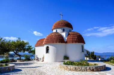 Nea Roda köyünün tepelerinde turuncu ve beyaz kilise ve Yunanistan 'ın Halkidiki kentindeki liman