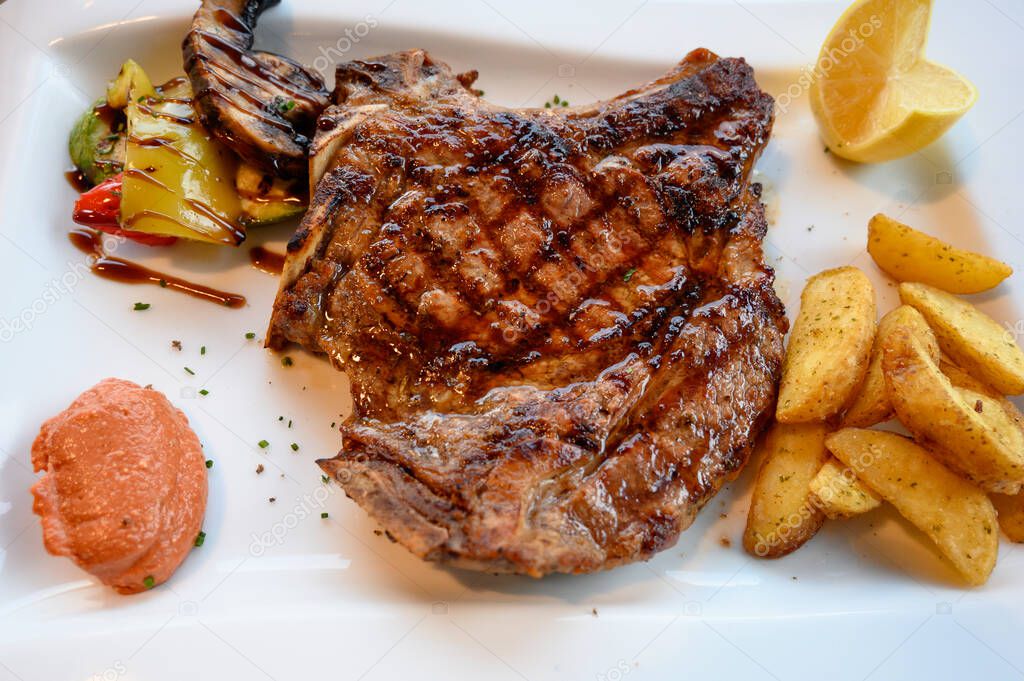 Grilled beef stake with potatoes in Greece restaurant