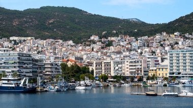 Ege Denizi 'nde liman ve demirli yatları olan birden fazla bina, Yunanistan' ın Kavala kentindeki yeşil tepe