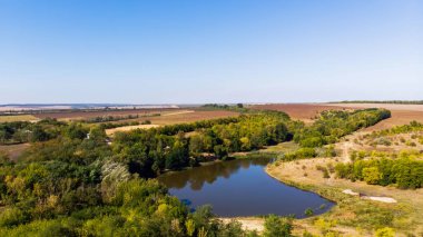 Boroseni 'deki göl ve orman, insansız hava aracı manzarası, arka planda tarlalar, Moldova