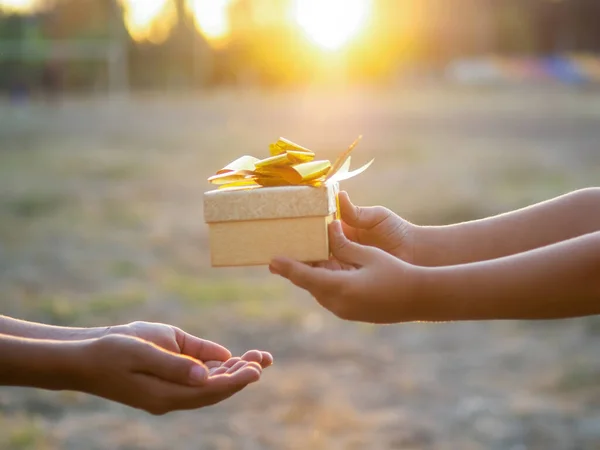 Een Kind Geeft Een Jongen Een Geschenkdoos Met Gouden Tape — Stockfoto