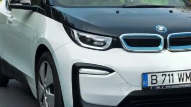 BUCHAREST, ROMANIA - 20 Ekim 2020: modern BMW i3 elektrikli araba şehir merkezinde yolda gidiyor. Sıfır emisyon aracının yakın görüntüsü. Ekoloji fikri