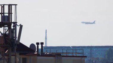 Yolcu uçağı konut binalarının üzerinden inmek üzere yaklaşıyor.