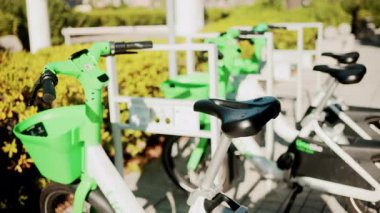 Cannes, Fransa - 13 Ekim 2025: Güneşli bir şehir bölgesinde park edilmiş yeşil elektrikli bisikletlere yakın çekim