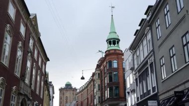 Copenhagen, Denmark - August 3, 2025: Shoppers enjoying a stroll along the famous Stroget shopping street filled with high end brands