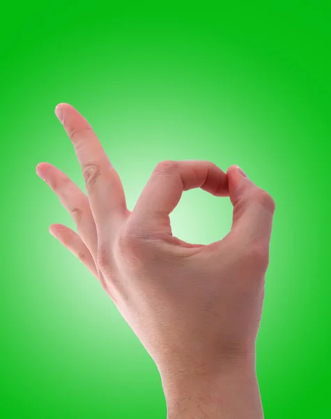 Ok hand sign on green background — Stock Photo, Image