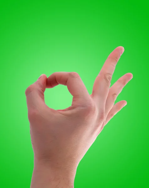 Ok hand sign on green background — Stock Photo, Image