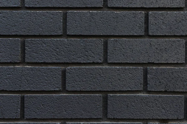 Close up of black brick wall texture background.