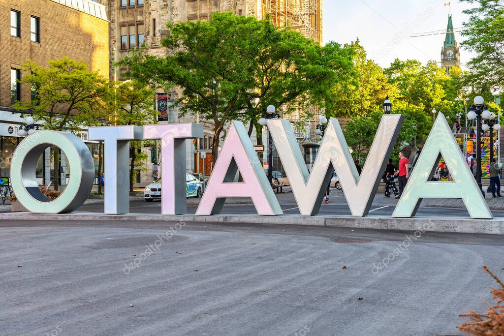 Ottawa, Canada May 23, 2021: Huge Ottawa sign in downtown at the Byward Market in spring, Peace Tower in the background. Popular place for tourists.