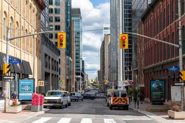 Ottawa, Kanada - 1 Temmuz 2021: Ottawa şehir merkezindeki trafik ışıklarıyla kesişen modern gökdelenler ve tarihi binalarla şehir manzarası.