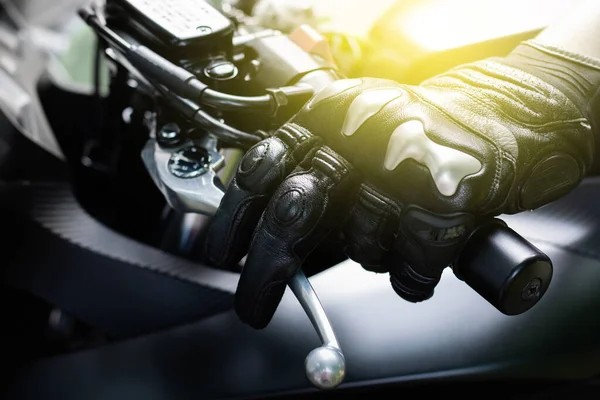 Close up of hand and clutch lever motorcycle, Hands wearing black leather gloves with a protective card grip the clutch lever bigbike motercycal.